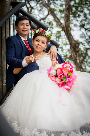 Married couple, man embracing woman on the ladderの写真素材