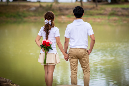 The back of the couple are holding hands.の写真素材