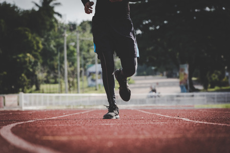 Male athlete running in the stadium.の写真素材