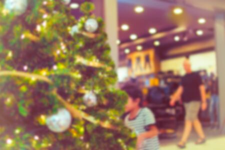 Colorful christmas tree light bokeh and blured in shopping mallの写真素材