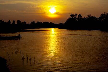 fisherman silhouette at moonnoi in thailandの写真素材