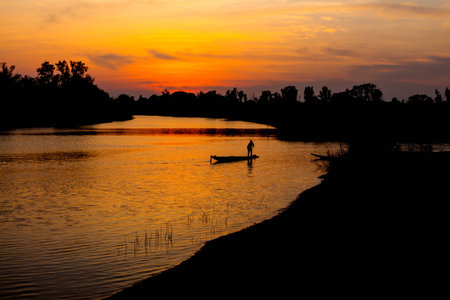 fisherman silhouette at moonnoi in thailandの写真素材