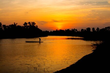 fisherman silhouette at moonnoi in thailandの写真素材