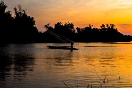 fisherman silhouette at moonnoi in thailandの写真素材