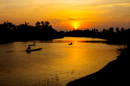 fisherman silhouette at moonnoi in thailandの写真素材