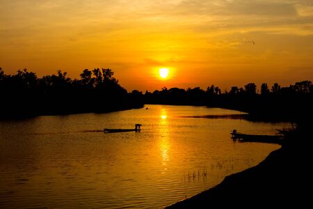 fisherman silhouette at moonnoi in thailandの写真素材