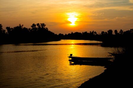 fisherman silhouette at moonnoi in thailandの写真素材
