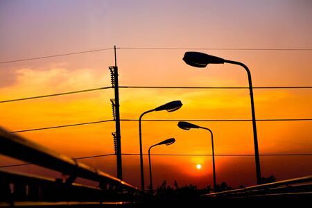 Silhouette Electric Lamp Whith Sunsetの写真素材