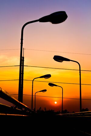 Silhouette Electric Lamp on Sunsetの写真素材