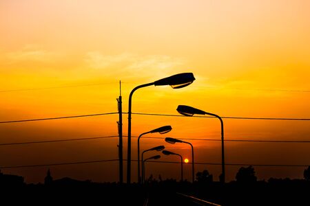 Silhouette Electric Lamp Whith Sunsetの写真素材