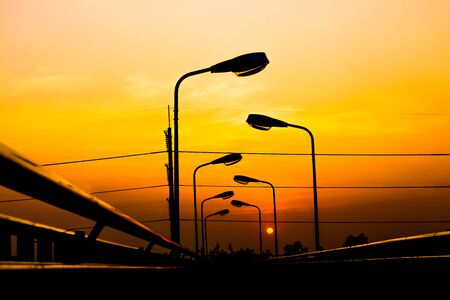 Silhouette Electric Lamp Whith Sunsetの写真素材