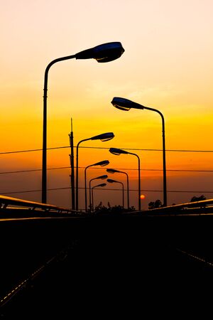 Silhouette Electric Lamp Whith Sunsetの写真素材