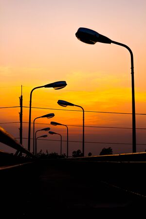 Silhouette Electric Lamp Whith Sunsetの写真素材