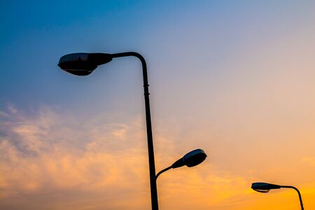 Silhouette Electric Lamp Whith Sunsetの写真素材