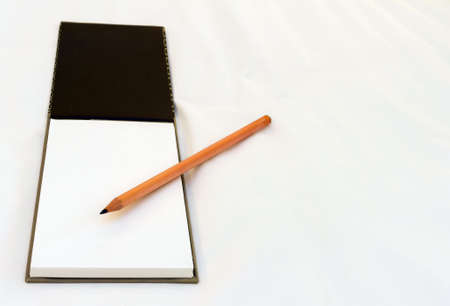 Notepad with white sheet of blank paper for your writing with pencilの写真素材