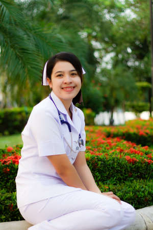 Cute nurse smiling with stethoscopeの写真素材