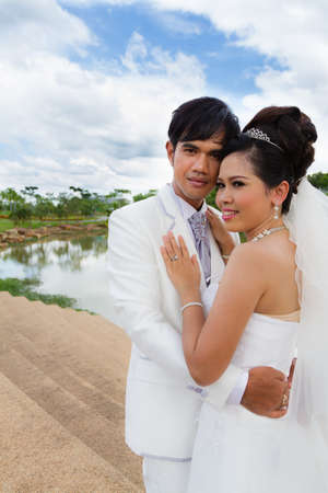 Asian groom and bride embrace の写真素材