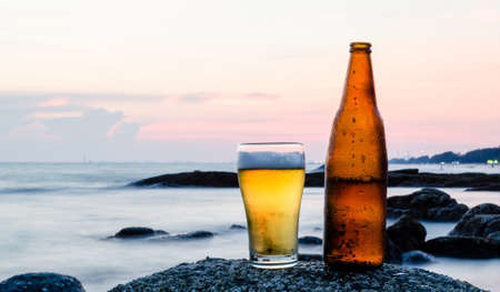 Glass of beer with sea backgroundの写真素材