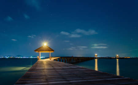 Wooded bridge in the port at nightの写真素材