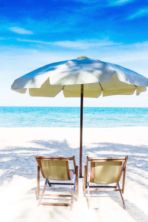 Two chairs and umbrella on stunning tropical beach, Thailandの写真素材