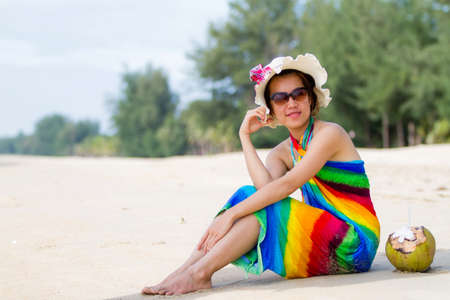 Beach hat profile girl with a coconut fresh cocktail in tropical Caribbean sea の写真素材