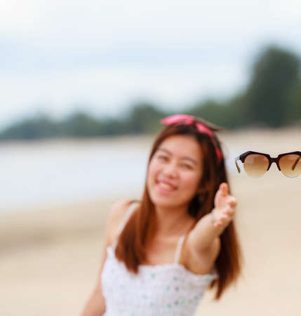 Woman and fancy sunglasses, close up on the beachの写真素材