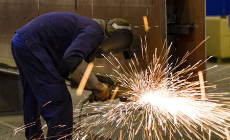 Electric wheel grinding on steel structure in factory の写真素材