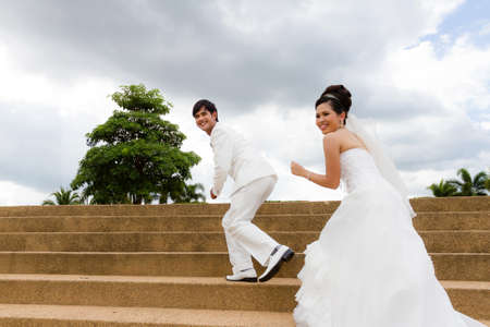 Young newly married couple chasing each otherの写真素材