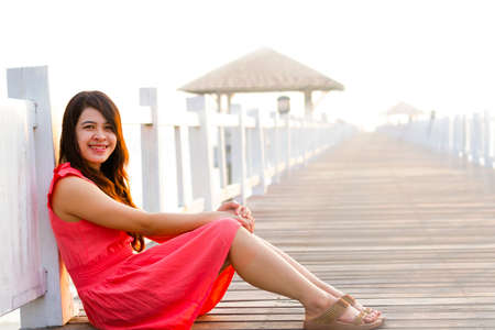 Asia woman is sitting on wood boardsの写真素材