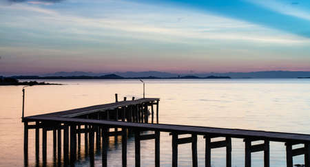 Wooded bridge in the port at twilightの写真素材