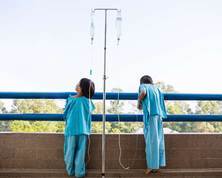 Sick Little boy and girl in hospitalの写真素材