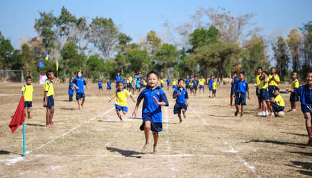 PHOCHAI,ROI-ET - JANUARY 10   Unidentified Thai students 4 - 12 years old athletes in action during sport day on January 10, 2014 in Ban Donrue school, Phochai, Roi-Et, Thailand  のeditorial素材