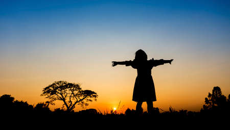 Little girl with sunset の写真素材