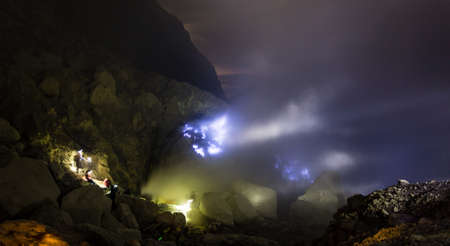 Blue fire a flow of liquid sulfur which has caught fire and burns with an blue flame  Cater of the Kawah Ijen volcano, Java, Indonesia の写真素材