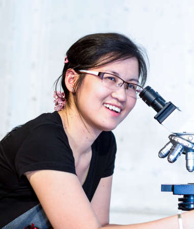 Scientist using a microscope in a laboratory