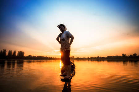 Fisherman on the boat, Thailandの写真素材