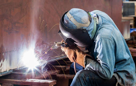 Worker with protective mask welding metal の写真素材