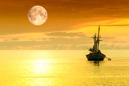 Sailboat and full moonの写真素材
