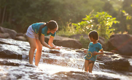Mother and daughter playing on hot summertimeの写真素材