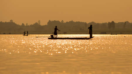 Fishermen in the boat sunriseの写真素材