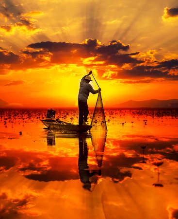 Fisherman of Lake in action when fishing, Thailandの写真素材