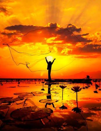 Fisherman of Lake in action when fishing, Thailandの写真素材