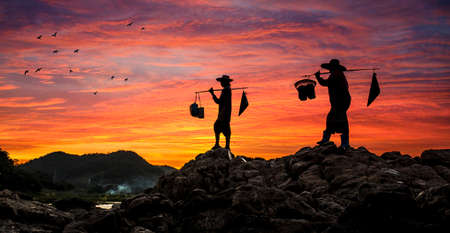 Thai farmer on sunset, Back to home after finish.の写真素材