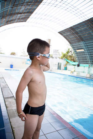 Boy smiling at the pool at the leisure centerの写真素材