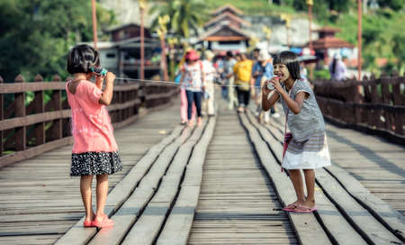 Asian girls talking on a can phoneの写真素材
