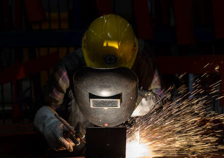 Worker with protective mask welding metalの写真素材