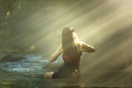 Asian woman in cascade, Thailandの写真素材