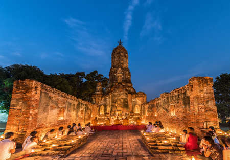 Ayutthaya, Thailand - February 22, 2016: People praying respect to monk on Ayutthaya. Roughly 95% of the Thai people are practitioners of Theravada Buddhism, the official religion of Thailandのeditorial素材