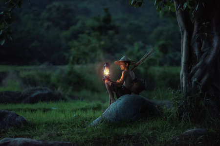 Boy fishing with lantern
