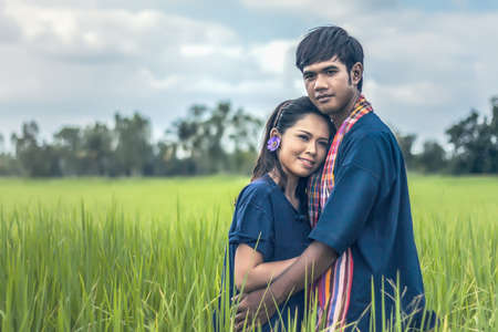 Couple farmer in farmer suit with on rice fieldsの写真素材